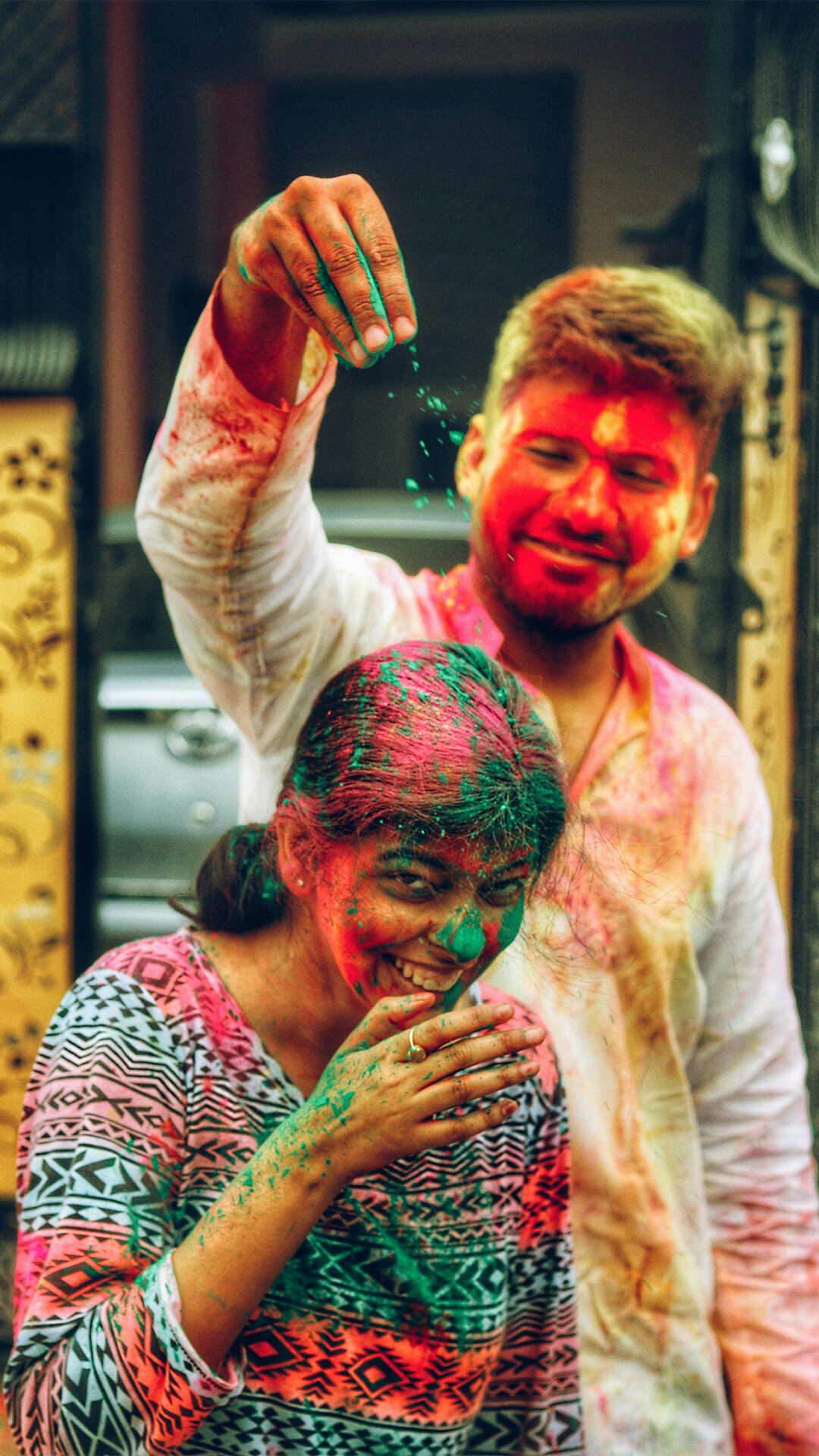 A man dropping colours on a girl hair 